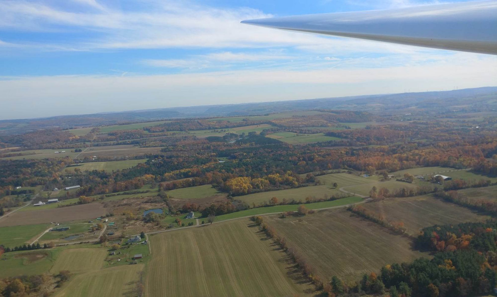 Finger Lakes landscape under a glider wing